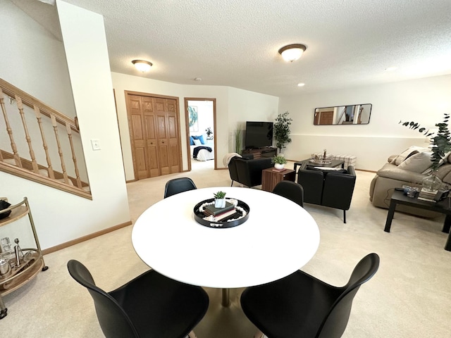 12224 Radisson Rd NE, Blaine, MN 55449 - dining room with light carpet, stairway, and a textured ceiling
