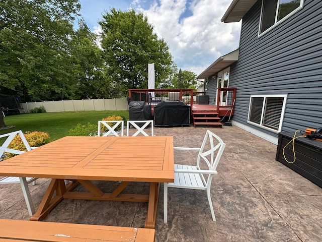 12224 Radisson Rd NE, Blaine, MN 55449 - view of patio featuring outdoor dining area and a deck
