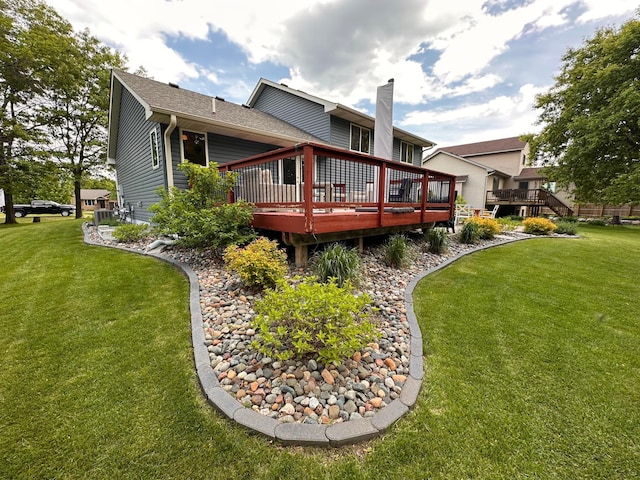 12224 Radisson Rd NE, Blaine, MN 55449 - back of house featuring a deck, a lawn, a chimney, and roof with shingles