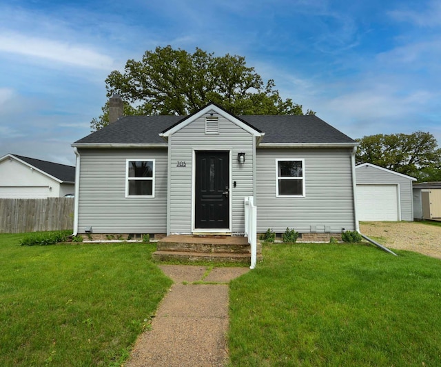 705 1st Ave SE, Pine Island, MN 55963 - bungalow featuring a chimney, a detached garage, an outbuilding, roof with shingles, and driveway