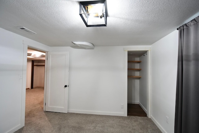 705 1st Ave SE, Pine Island, MN 55963 - unfurnished bedroom featuring carpet floors, a textured ceiling, a closet, and baseboards