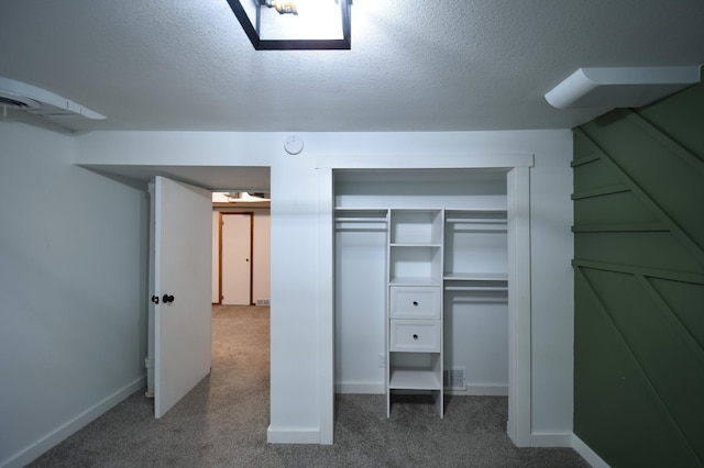 705 1st Ave SE, Pine Island, MN 55963 - unfurnished bedroom featuring carpet, a textured ceiling, baseboards, and a closet
