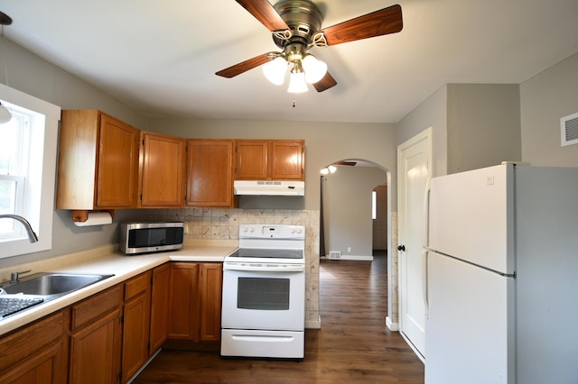 705 1st Ave SE, Pine Island, MN 55963 - kitchen featuring white appliances, under cabinet range hood, arched walkways, ceiling fan, and light countertops
