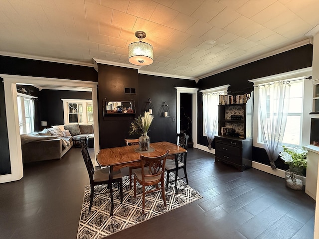206 Oscar Ave N, Canby, MN 56220 - dining space with crown molding, plenty of natural light, and dark wood-style floors