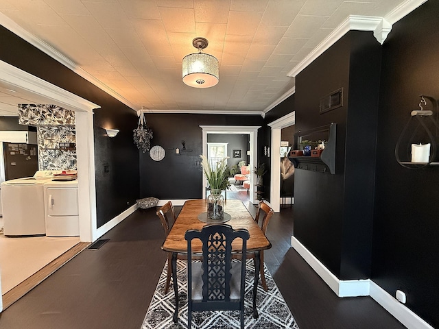 206 Oscar Ave N, Canby, MN 56220 - dining room featuring ornamental molding, washer and clothes dryer, and wood finished floors
