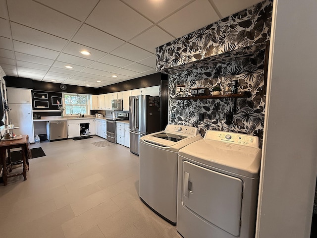206 Oscar Ave N, Canby, MN 56220 - washroom featuring wallpapered walls, washer and clothes dryer, and recessed lighting