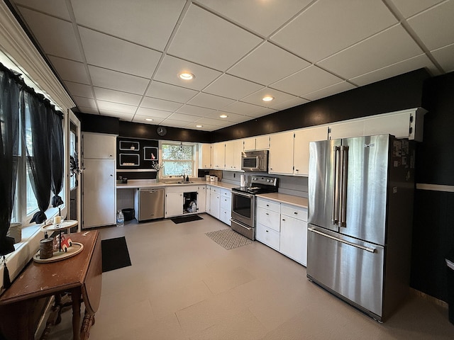 206 Oscar Ave N, Canby, MN 56220 - kitchen with stainless steel appliances, a drop ceiling, light countertops, white cabinets, and recessed lighting