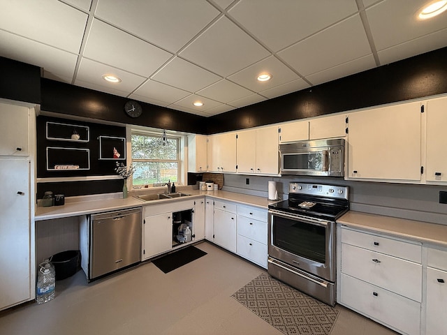 206 Oscar Ave N, Canby, MN 56220 - kitchen with appliances with stainless steel finishes, a drop ceiling, white cabinets, light countertops, and recessed lighting