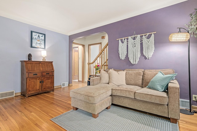 1391 Jefferson Ave, Saint Paul, MN 55105 - living room with arched walkways, light wood-style floors, baseboards, and stairs