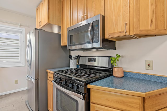 1391 Jefferson Ave, Saint Paul, MN 55105 - kitchen featuring appliances with stainless steel finishes, light tile patterned floors, light brown cabinetry, and baseboards
