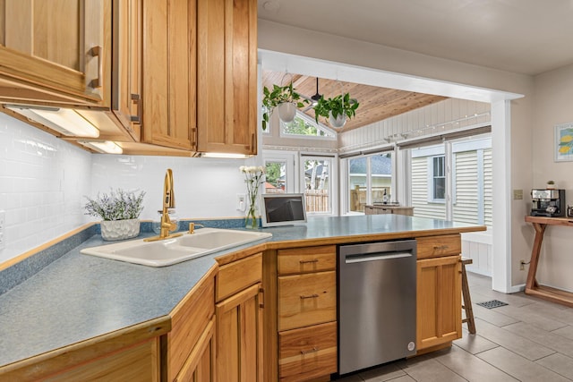 1391 Jefferson Ave, Saint Paul, MN 55105 - kitchen featuring stainless steel dishwasher, a sink, a peninsula, light tile patterned floors, and vaulted ceiling