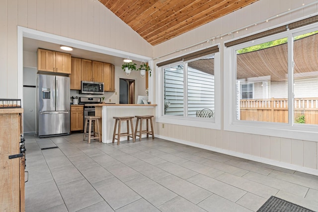 1391 Jefferson Ave, Saint Paul, MN 55105 - kitchen featuring appliances with stainless steel finishes, lofted ceiling, wooden ceiling, a breakfast bar area, and light tile patterned floors
