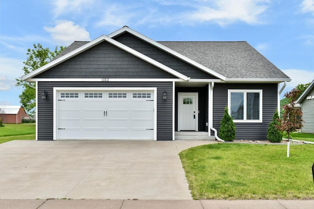 1160 21st St, Wabasha, MN 55981 - view of front facade featuring driveway, a front yard, a garage, and a shingled roof