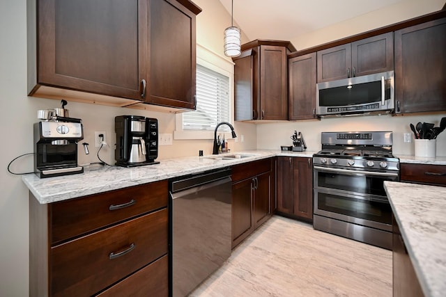 1160 21st St, Wabasha, MN 55981 - kitchen with stainless steel appliances, a sink, dark brown cabinetry, and light stone countertops
