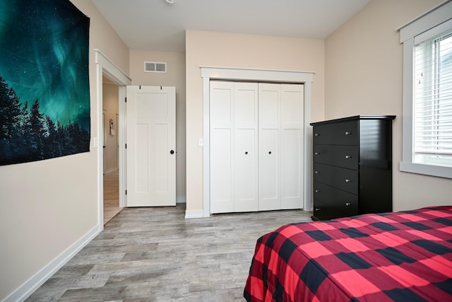 1160 21st St, Wabasha, MN 55981 - bedroom featuring wood finished floors, multiple windows, a closet, and baseboards