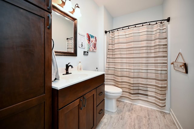 1160 21st St, Wabasha, MN 55981 - bathroom with vanity, wood finished floors, and toilet