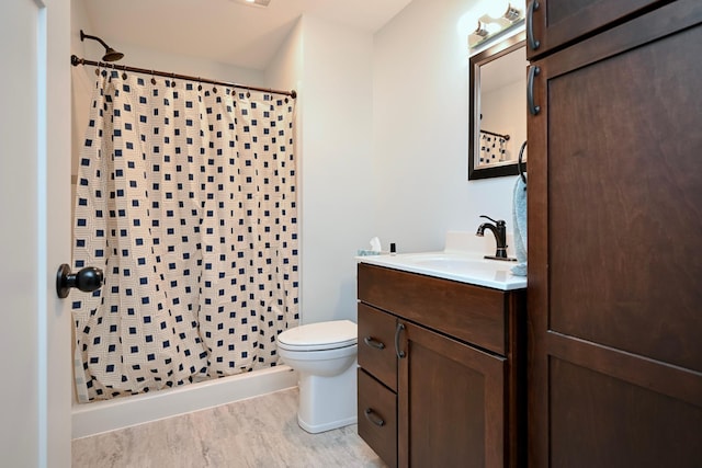 1160 21st St, Wabasha, MN 55981 - full bathroom featuring vanity, curtained shower, toilet, and wood finished floors