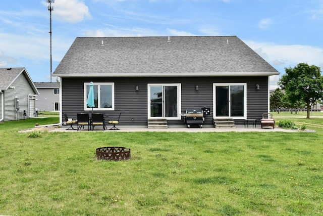 1160 21st St, Wabasha, MN 55981 - rear view of property featuring entry steps, a patio area, a lawn, and a fire pit