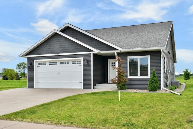 1160 21st St, Wabasha, MN 55981 - view of front of home with driveway, central AC unit, an attached garage, a front yard, and a shingled roof