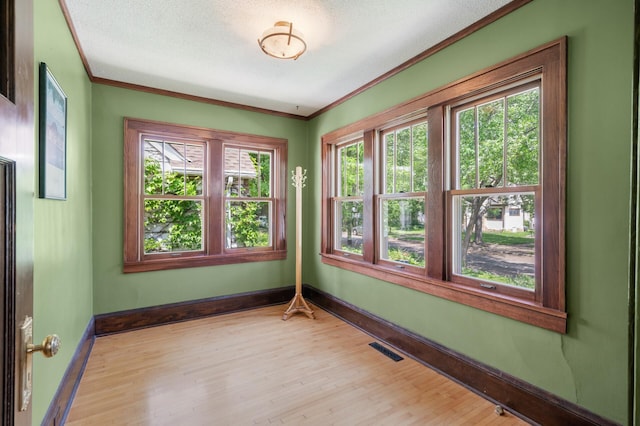 5136 16th Ave S, Minneapolis, MN 55417 - spare room featuring crown molding, baseboards, wood finished floors, and a textured ceiling