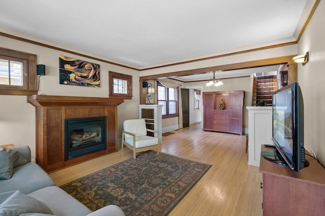 5136 16th Ave S, Minneapolis, MN 55417 - living area with light wood-style flooring, a glass covered fireplace, ornamental molding, and baseboards