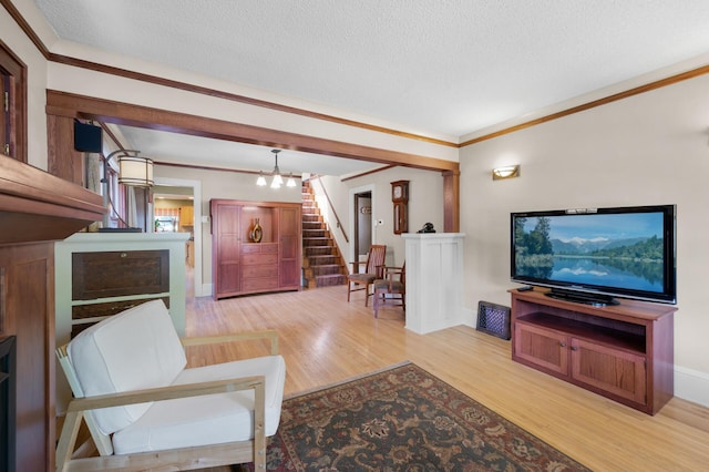 5136 16th Ave S, Minneapolis, MN 55417 - living area with stairs, a textured ceiling, wood finished floors, ornamental molding, and baseboards