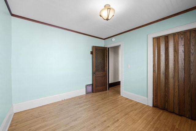 5136 16th Ave S, Minneapolis, MN 55417 - unfurnished bedroom with light wood-type flooring, baseboards, ornamental molding, and a closet