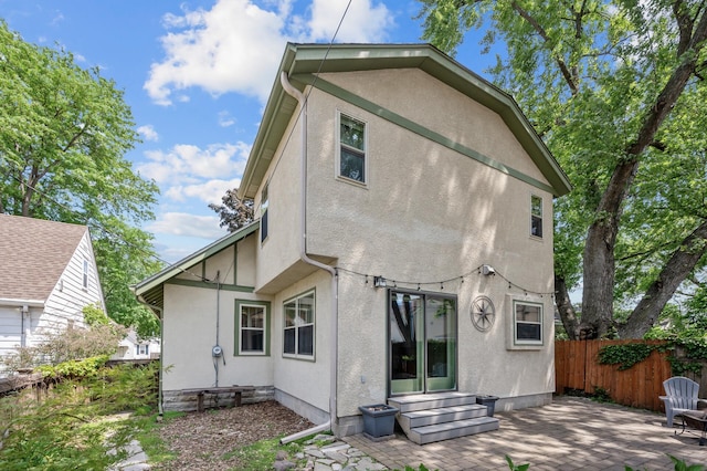 5136 16th Ave S, Minneapolis, MN 55417 - back of property featuring stucco siding, entry steps, and a patio area