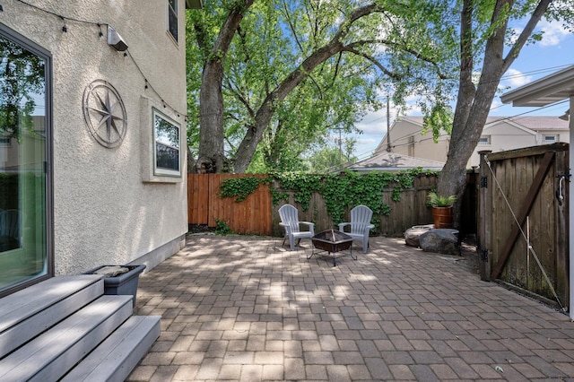 5136 16th Ave S, Minneapolis, MN 55417 - fenced backyard featuring a patio area, a fire pit, and a gate