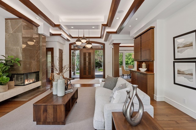370 Ferndale Rd W, Wayzata, MN 55391 - living area with wood finished floors, ornate columns, recessed lighting, a fireplace, and baseboards