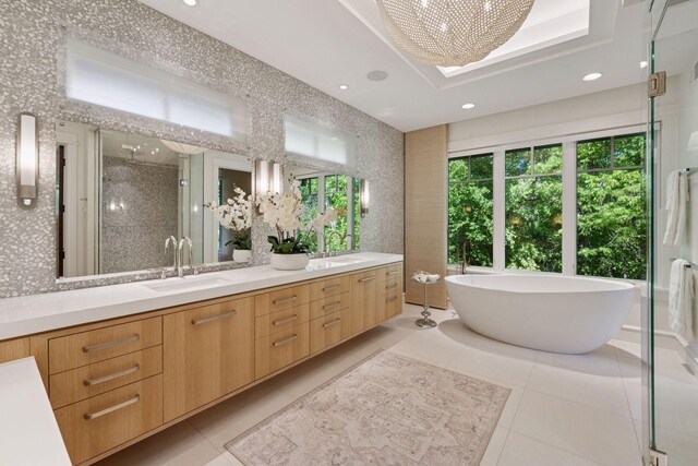 370 Ferndale Rd W, Wayzata, MN 55391 - bathroom featuring double vanity, tile patterned floors, a shower stall, a soaking tub, and healthy amount of natural light