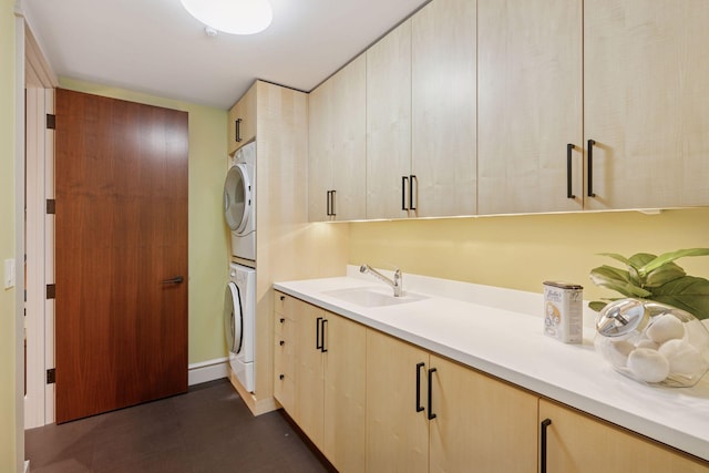 370 Ferndale Rd W, Wayzata, MN 55391 - washroom with stacked washer / drying machine, cabinet space, baseboards, and dark flooring