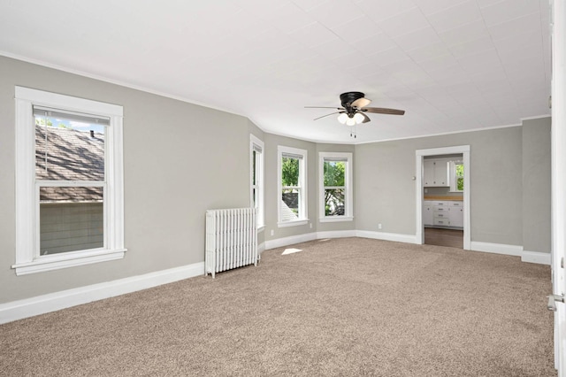 857 Oakdale Ave, Saint Paul, MN 55107 - carpeted empty room featuring radiator, ceiling fan, plenty of natural light, baseboards, and crown molding