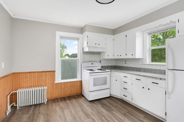 857 Oakdale Ave, Saint Paul, MN 55107 - kitchen featuring white appliances, radiator heating unit, wood finished floors, a wainscoted wall, and extractor fan