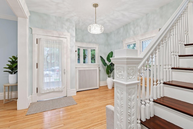 1929 Humboldt Ave S, Minneapolis, MN 55403 - foyer featuring radiator heating unit, stairs, wood finished floors, a chandelier, and baseboards