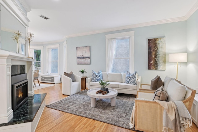 1929 Humboldt Ave S, Minneapolis, MN 55403 - living room with ornamental molding, healthy amount of natural light, wood finished floors, and a glass covered fireplace