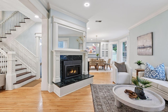1929 Humboldt Ave S, Minneapolis, MN 55403 - living area with ornamental molding, stairs, light wood-style floors, healthy amount of natural light, and recessed lighting