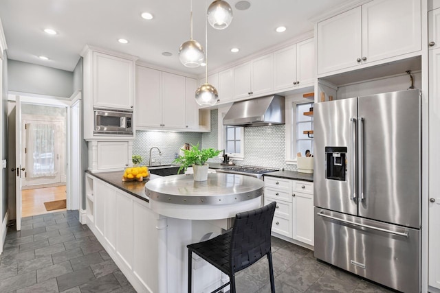 1929 Humboldt Ave S, Minneapolis, MN 55403 - kitchen featuring appliances with stainless steel finishes, range hood, dark countertops, backsplash, and white cabinets