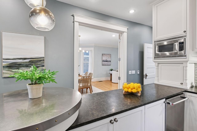 1929 Humboldt Ave S, Minneapolis, MN 55403 - kitchen with stainless steel microwave, white cabinets, dark countertops, and recessed lighting