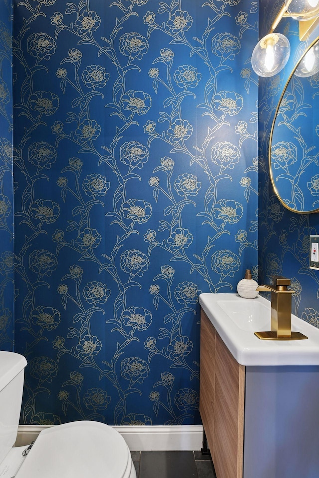 1929 Humboldt Ave S, Minneapolis, MN 55403 - bathroom featuring toilet, wallpapered walls, vanity, baseboards, and tile patterned floors