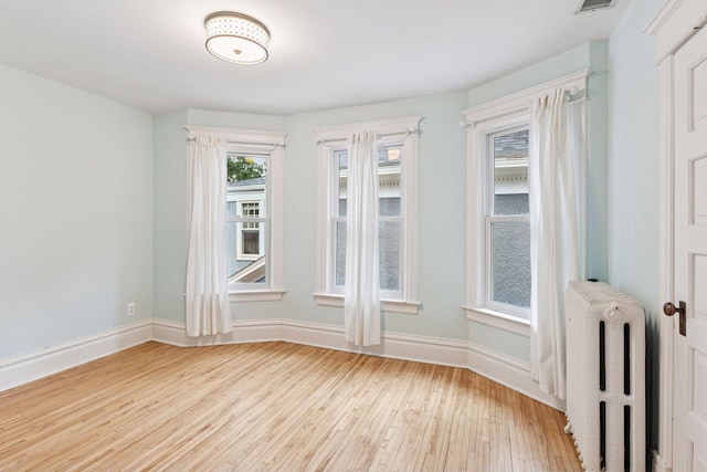 1929 Humboldt Ave S, Minneapolis, MN 55403 - spare room featuring radiator, hardwood / wood-style flooring, and baseboards