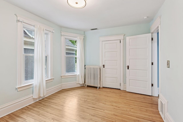 1929 Humboldt Ave S, Minneapolis, MN 55403 - unfurnished bedroom with radiator heating unit, light wood-style flooring, and baseboards