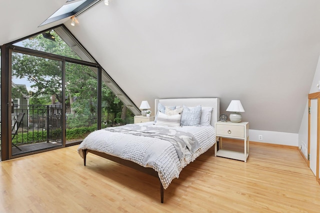 1929 Humboldt Ave S, Minneapolis, MN 55403 - bedroom featuring access to exterior, wood finished floors, a wall of windows, baseboards, and track lighting