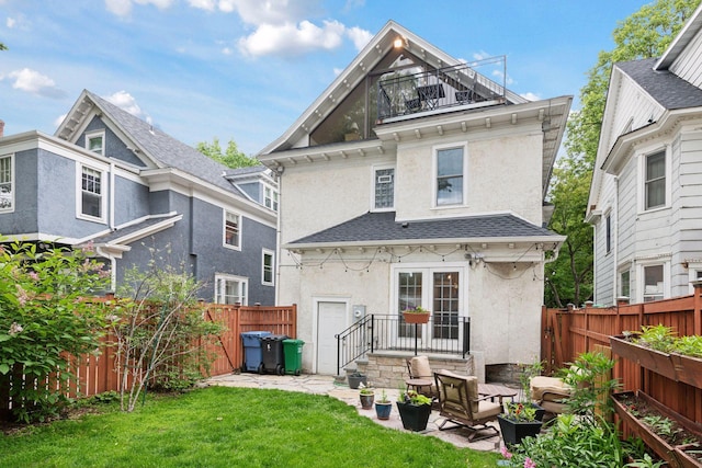 1929 Humboldt Ave S, Minneapolis, MN 55403 - rear view of property featuring stucco siding, roof with shingles, a balcony, and a patio area