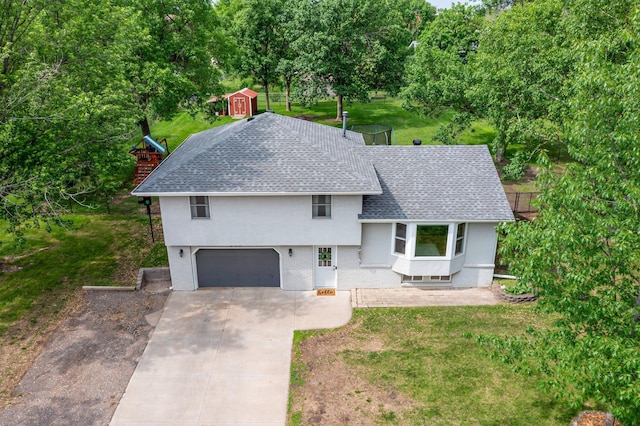 713 9th St NW, Buffalo, MN 55313 - view of front of house featuring a shingled roof, concrete driveway, an attached garage, stucco siding, and a front lawn