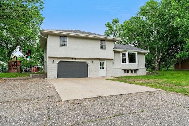 713 9th St NW, Buffalo, MN 55313 - tri-level home featuring an attached garage, stucco siding, a front yard, and brick siding