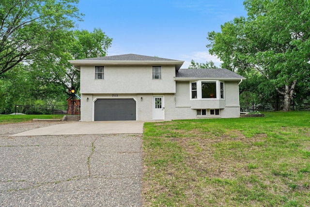 713 9th St NW, Buffalo, MN 55313 - split level home featuring a garage, concrete driveway, a front lawn, stucco siding, and brick siding