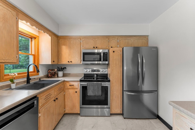 713 9th St NW, Buffalo, MN 55313 - kitchen featuring appliances with stainless steel finishes, a sink, light marble finish floors, and light countertops
