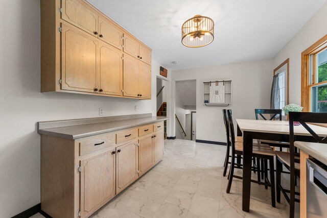 713 9th St NW, Buffalo, MN 55313 - kitchen featuring light marble finish flooring, light brown cabinetry, a chandelier, and stainless steel dishwasher