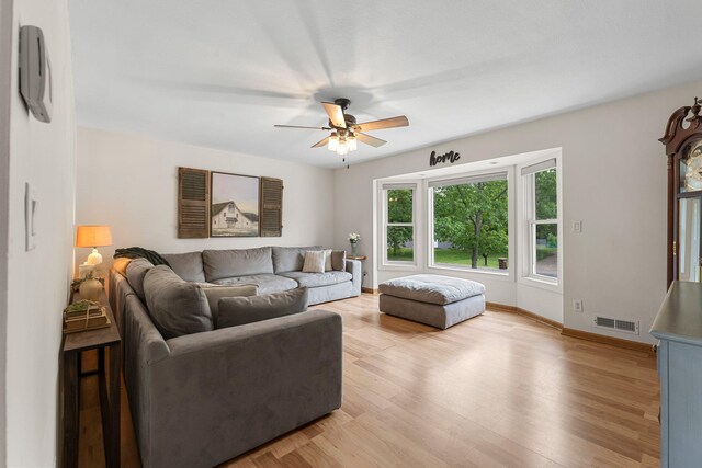 713 9th St NW, Buffalo, MN 55313 - living area with a ceiling fan, light wood-type flooring, and baseboards
